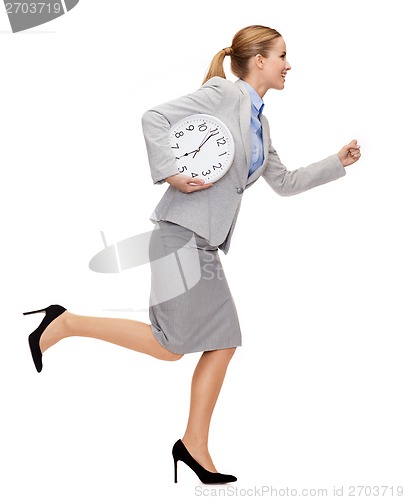 Image of smiling young businesswoman with clock running