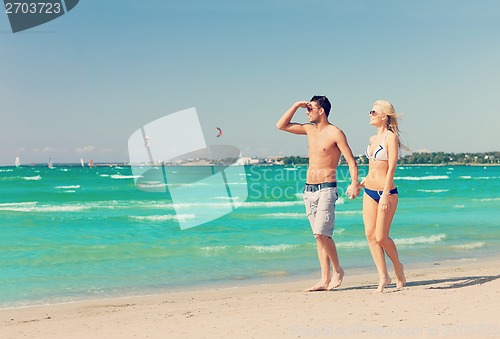 Image of couple walking on the beach