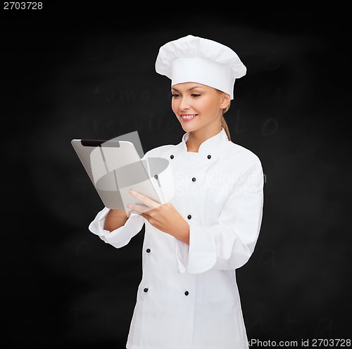 Image of smiling female chef with tablet pc computer