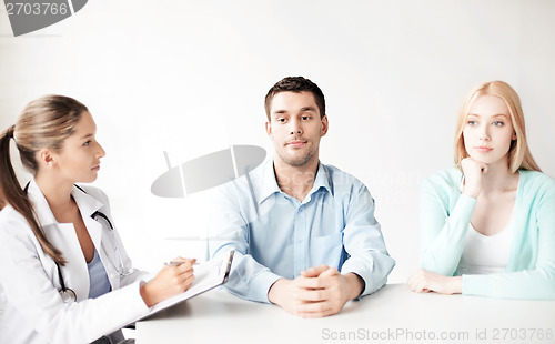 Image of doctor with patients in cabinet