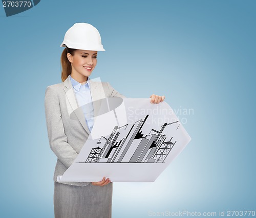 Image of smiling architect in white helmet with blueprints