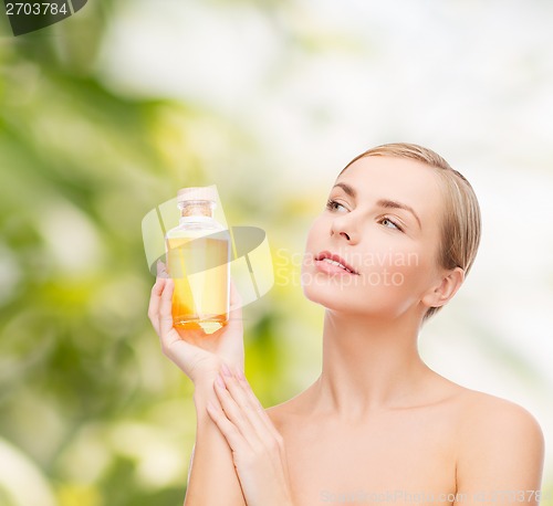 Image of lovely woman with oil bottle