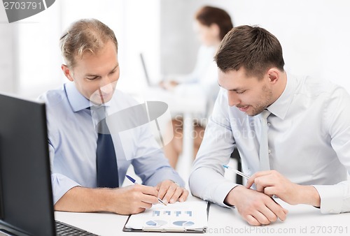 Image of businessmen with notebook on meeting