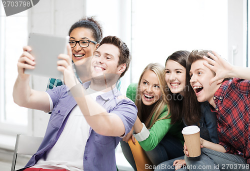 Image of students making picture with tablet pc at school