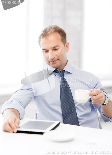 Image of businessman with tablet pc and coffee in office