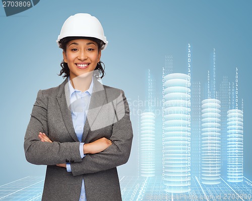 Image of businesswoman in white helmet with crossed arms