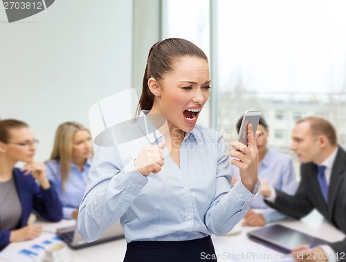 Image of screaming businesswoman with smartphone