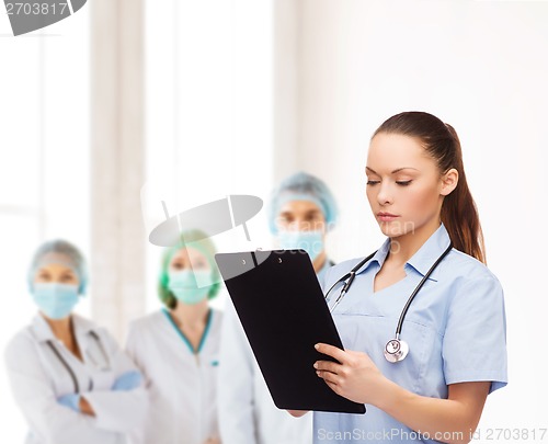 Image of serious female doctor or nurse with stethoscope