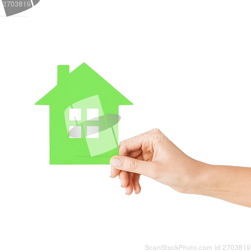 Image of hand holding green paper house