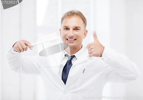 Image of dentist with toothbrush in hospital