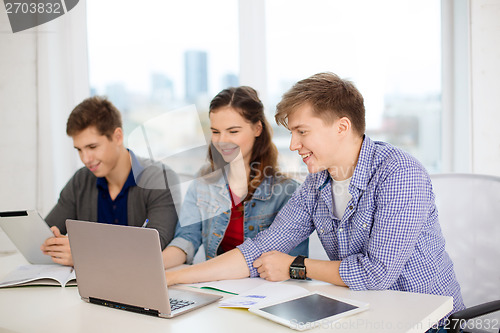 Image of students with laptop, notebooks and tablet pc