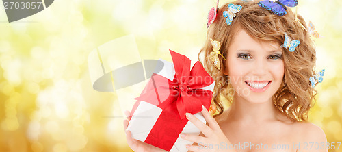 Image of teenager with butterflies in hair showing present