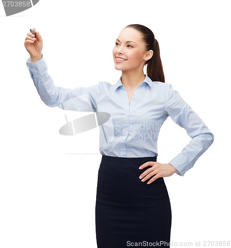 Image of businesswoman writing in the air with marker