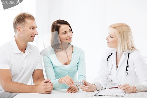 Image of doctor giving pills to patients