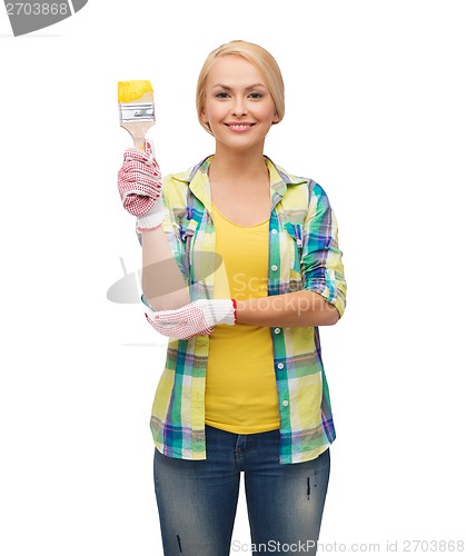 Image of smiling woman with paintbrush