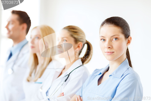 Image of female doctor or nurse in front of medical group