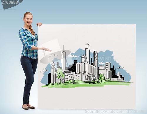 Image of smiling young woman with board and city drawing