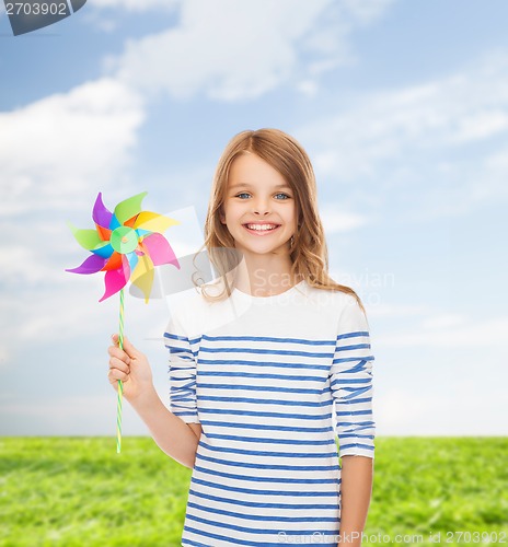 Image of smiling child with colorful windmill toy