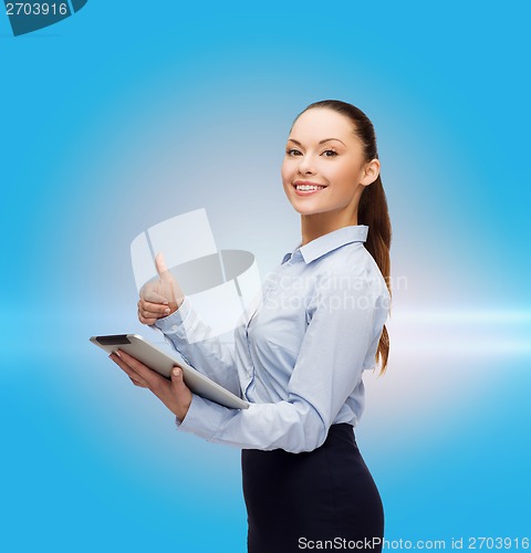 Image of smiling woman looking at tablet pc computer