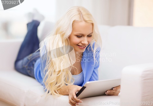 Image of smiling woman with tablet pc computer at home