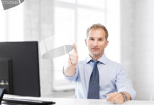 Image of smiling businessman showing thumbs up