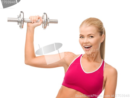 Image of smiling woman with heavy steel dumbbell