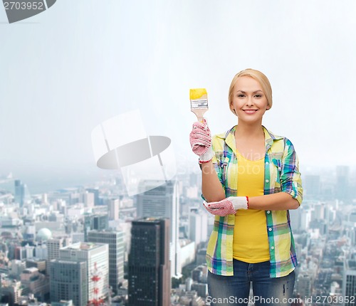 Image of smiling woman with paintbrush