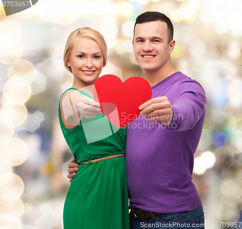 Image of smiling couple holding big red heart