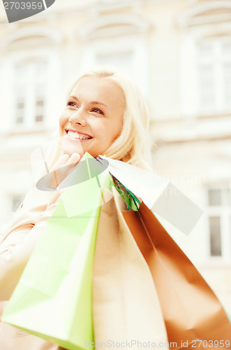 Image of woman with shopping bags in city