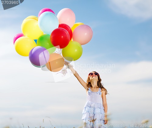 Image of happy girl with colorful balloons