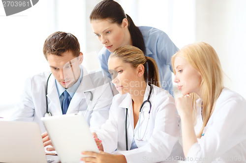 Image of group of doctors with laptop and tablet pc