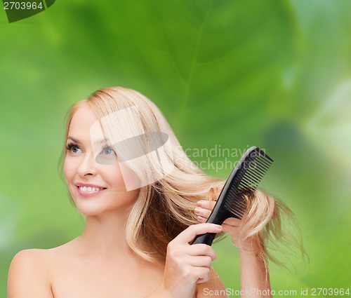 Image of smiling woman with hair brush