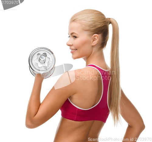 Image of smiling woman with heavy steel dumbbell