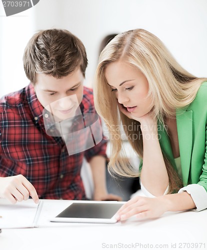 Image of students looking at tablet pc at school