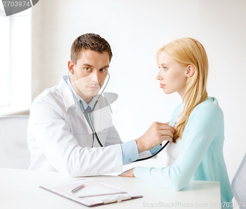 Image of doctor with stethoscope listening to the patient