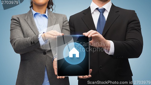 Image of businessman and businesswoman with tablet pc