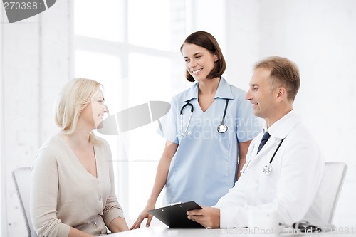 Image of doctor and nurse with patient in hospital