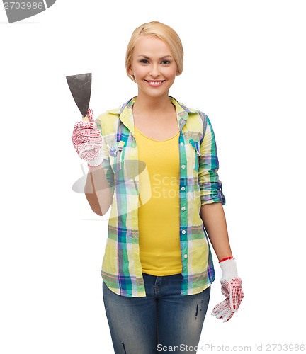 Image of smiling female worker in gloves with spatula