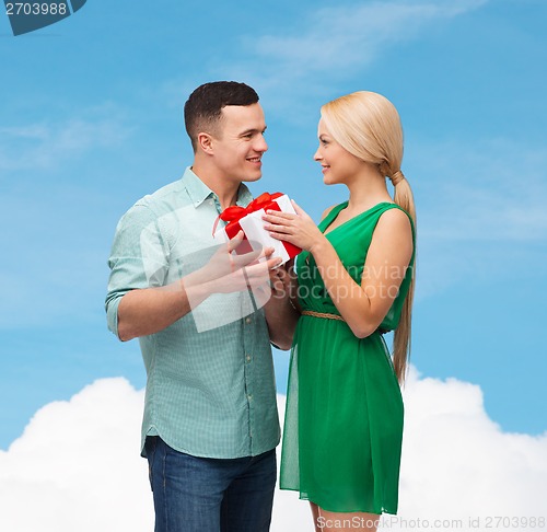 Image of smiling couple with gift box