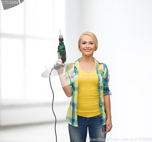 Image of smiling woman with drill machine