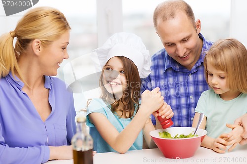 Image of happy family with two kids eating at home