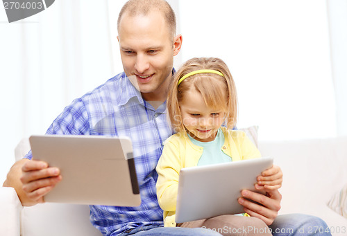Image of happy father and daughter with tablet pc computer