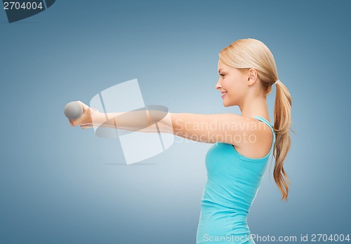 Image of young sporty woman with light dumbbells