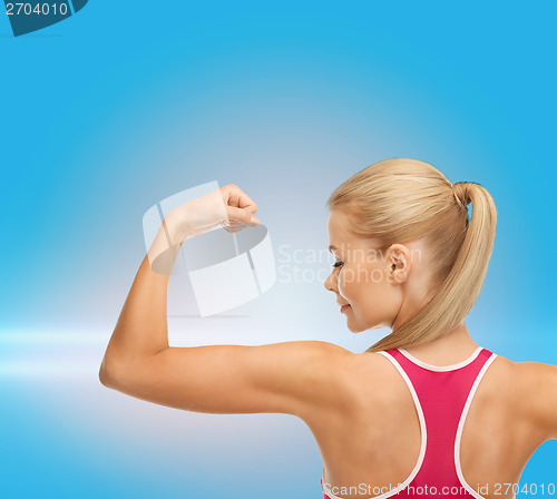 Image of sporty woman showing her biceps