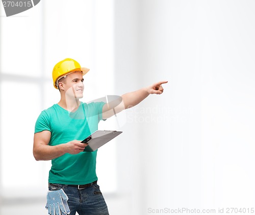 Image of smiling man in helmet with clipboard