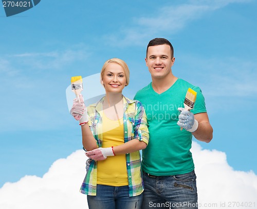 Image of smiling couple with paintbrush