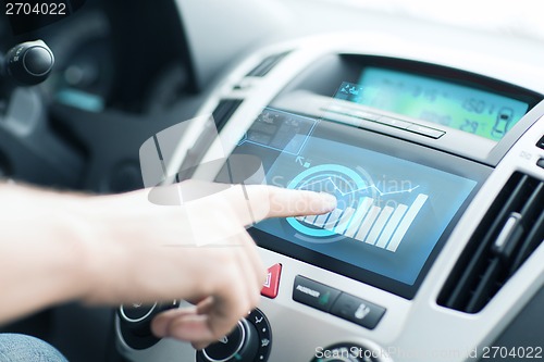 Image of man using car control panel