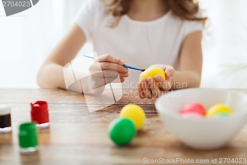 Image of close up of girl coloring eggs for easter