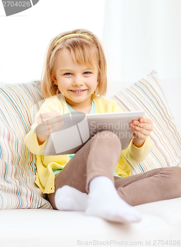 Image of smiling girl with tablet pc computer at home