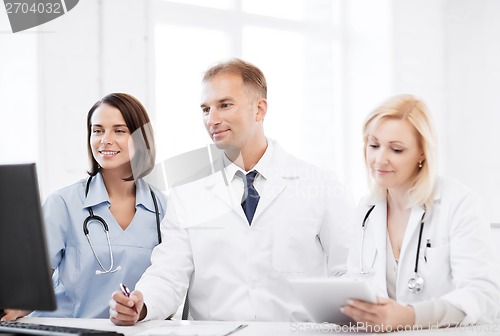 Image of doctors looking at computer on meeting